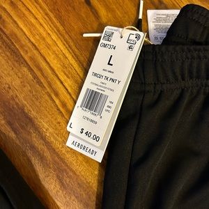 Adidas
Size youth Large, black with white stripes 
New with tags